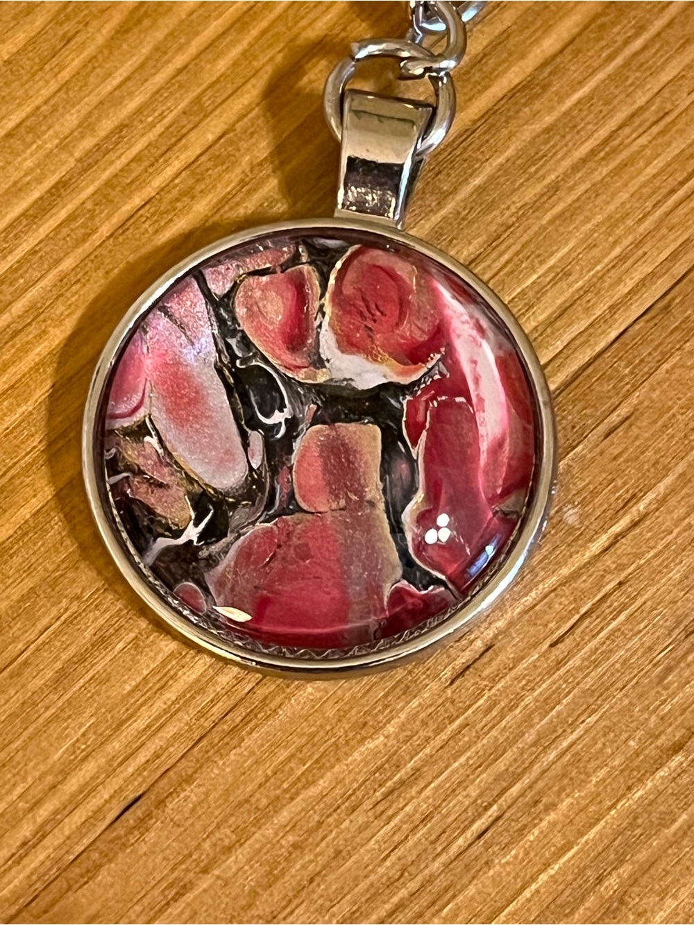 Silver tone key chain with circle design with tie dye mixed pink black silver 3”